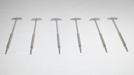 Six uniquely shaped metal rods positioned together for comparison.
