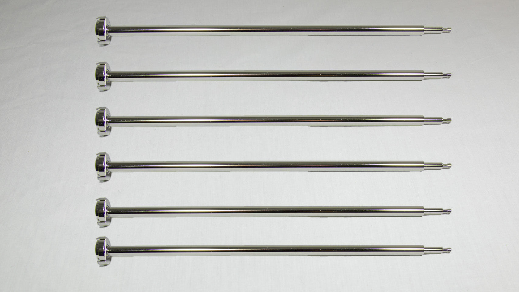 Six uniquely shaped metal rods positioned together for comparison.
