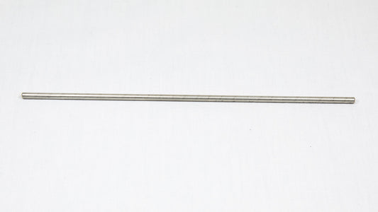A long cylindrical shaped object pictured on a white background, creating a minimalist composition of everyday items.