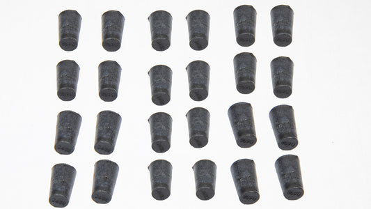 A collection of black rubber plugs arranged on a clean white surface.