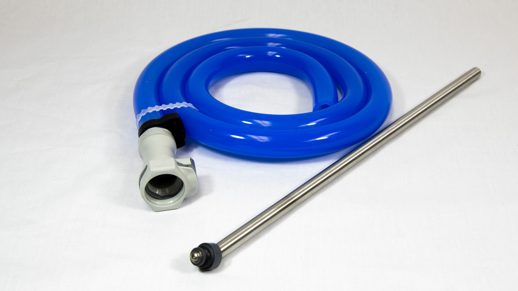 A blue hose and a metal rod are placed on a clean white surface, showcasing their contrasting colors and materials.
