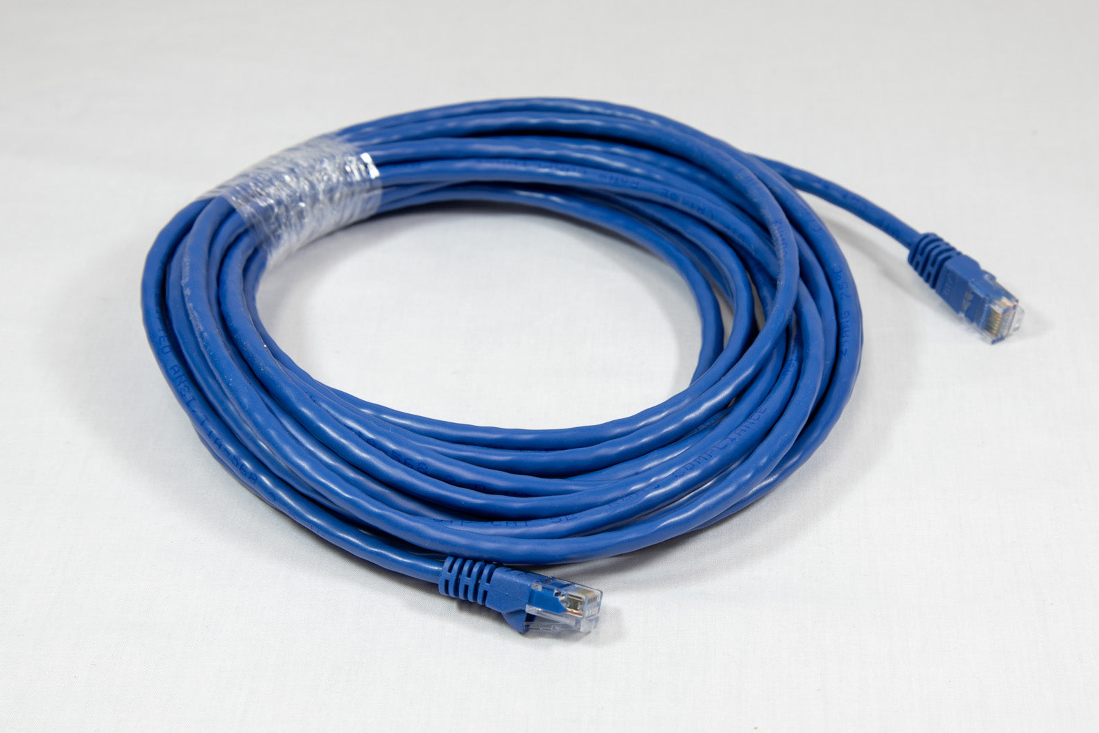 A blue Ethernet cable lies against a clean white background, showcasing its vibrant color and sleek design.