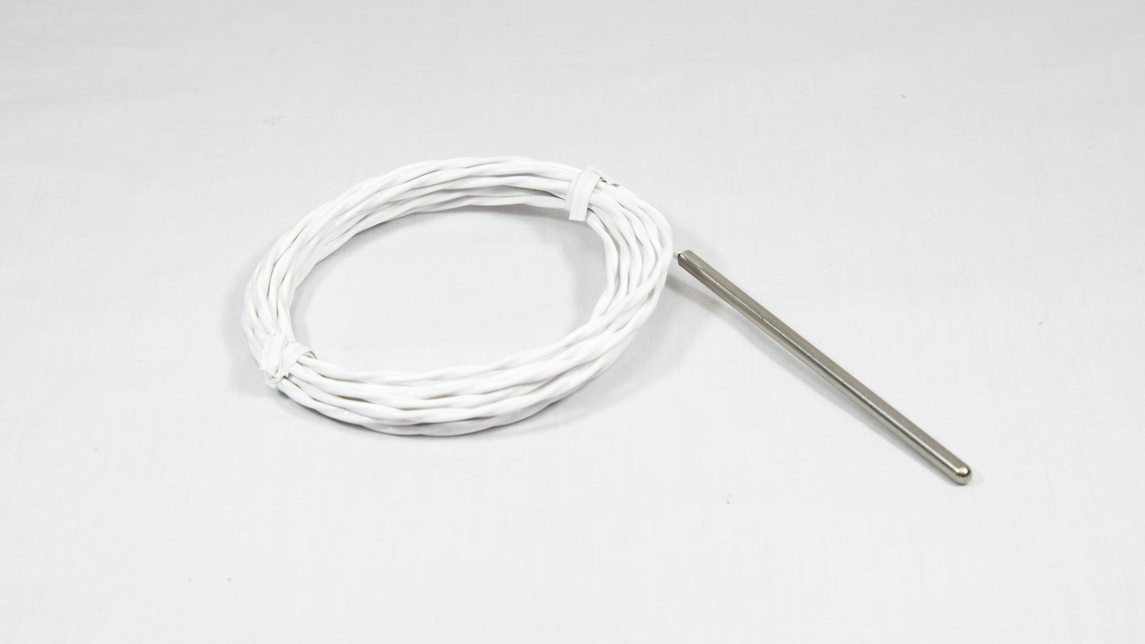 A close-up of a white cable with a stainless steel probe attached.